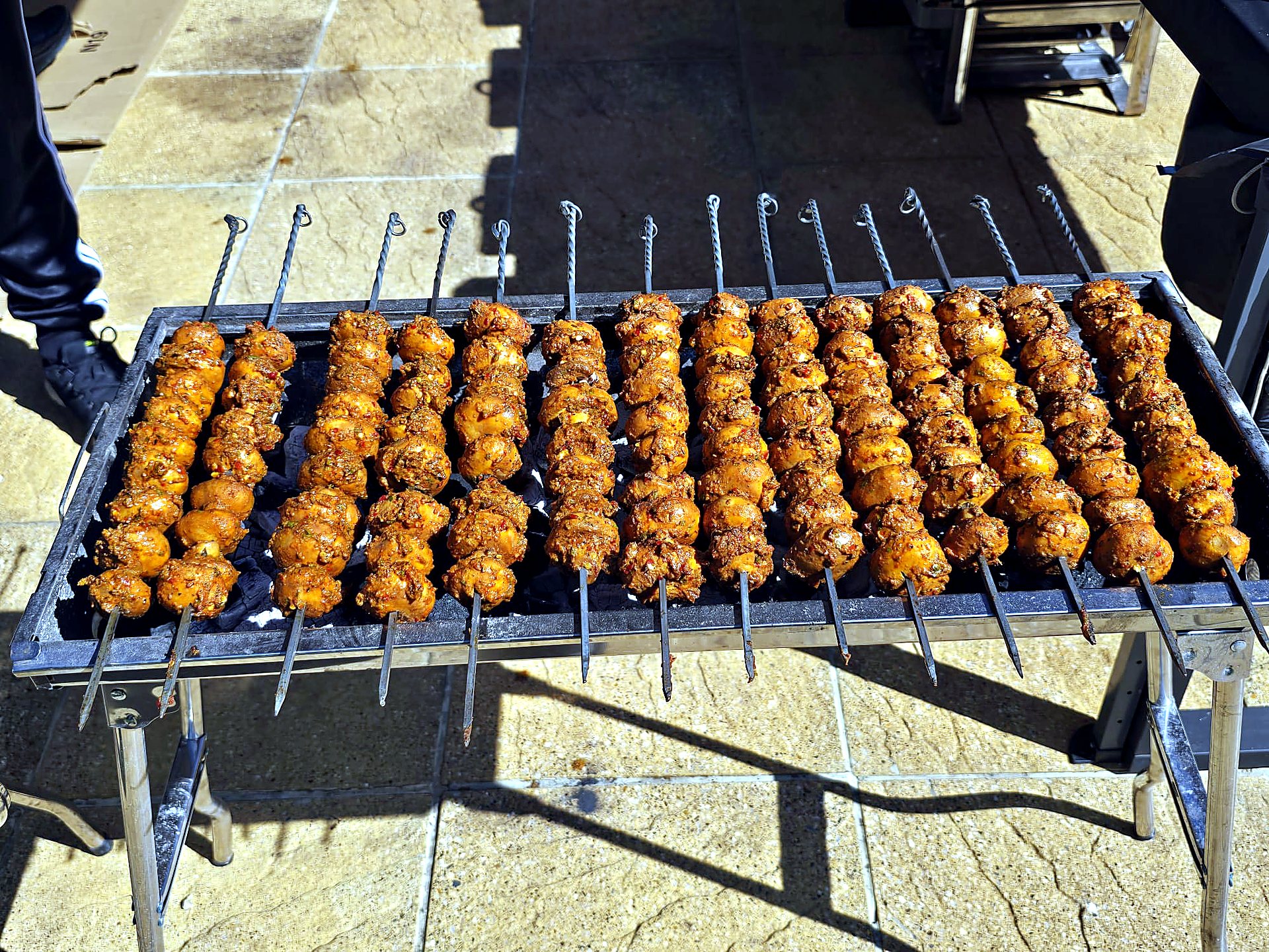 Chef preparing chicken tikka skewers
