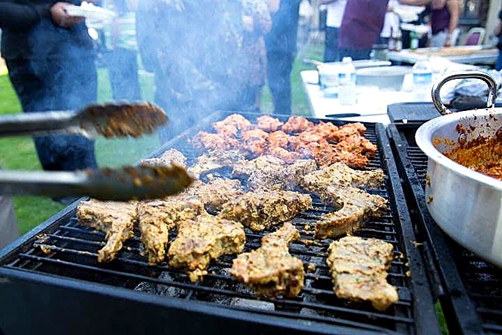 Flames and smoke rising from the live BBQ grill
